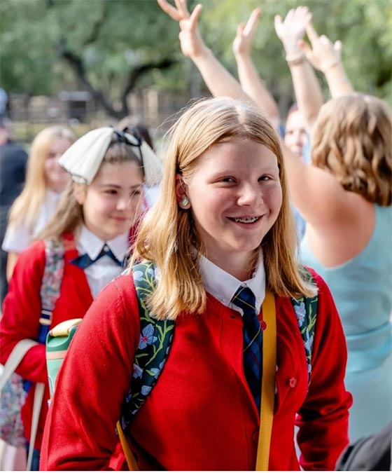 smiling girl entering the Texas Girls School