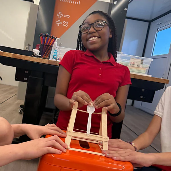 smiling-girl-red-shirt smiling girl in red school uniform showing her project