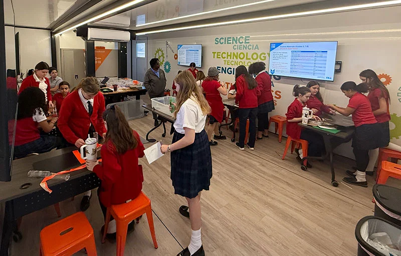 All girl students in class working on various projects